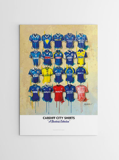 Artwork by Terry Kneeshaw depicting a collection of sixteen iconic Cardiff City football jerseys worn by the club's legends throughout their history. The kits feature the Cardiff City crest and kit manufacturer logos on the front, with a variety of home and away designs in blue and white, as well as alternative colours. The artwork is a high-quality A2 sized limited edition print of a hand-painted original, which uses textured brushstrokes to create a dynamic effect.
