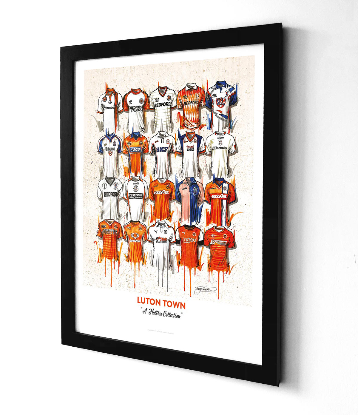 featuring 20 iconic jerseys from the team. The jerseys are arranged in a grid pattern, with the Luton FC crest at the centre. The jerseys feature different designs and colours, representing different eras of the team's history. The print is A2 size and is a limited edition print.