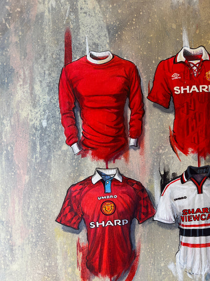 The Man United 2022 Personalised A2 Limited Edition Print Artwork by Terry Kneeshaw features 20 iconic jerseys in a unique and stylish design. This artwork showcases the team's rich history with jerseys from the past and present, including the iconic red and white striped shirt and the 2022 kit. The perfect addition to any Man United fan's collection, this artwork captures the essence of the club's history and tradition while celebrating the team's present and future.